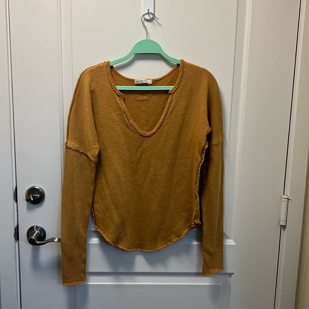 We the Free Free People Long sleeve v neck sweater with raw edges.